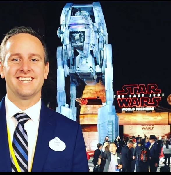 Tim posing in front of a Star Wars attraction in Disneyland Resort in California