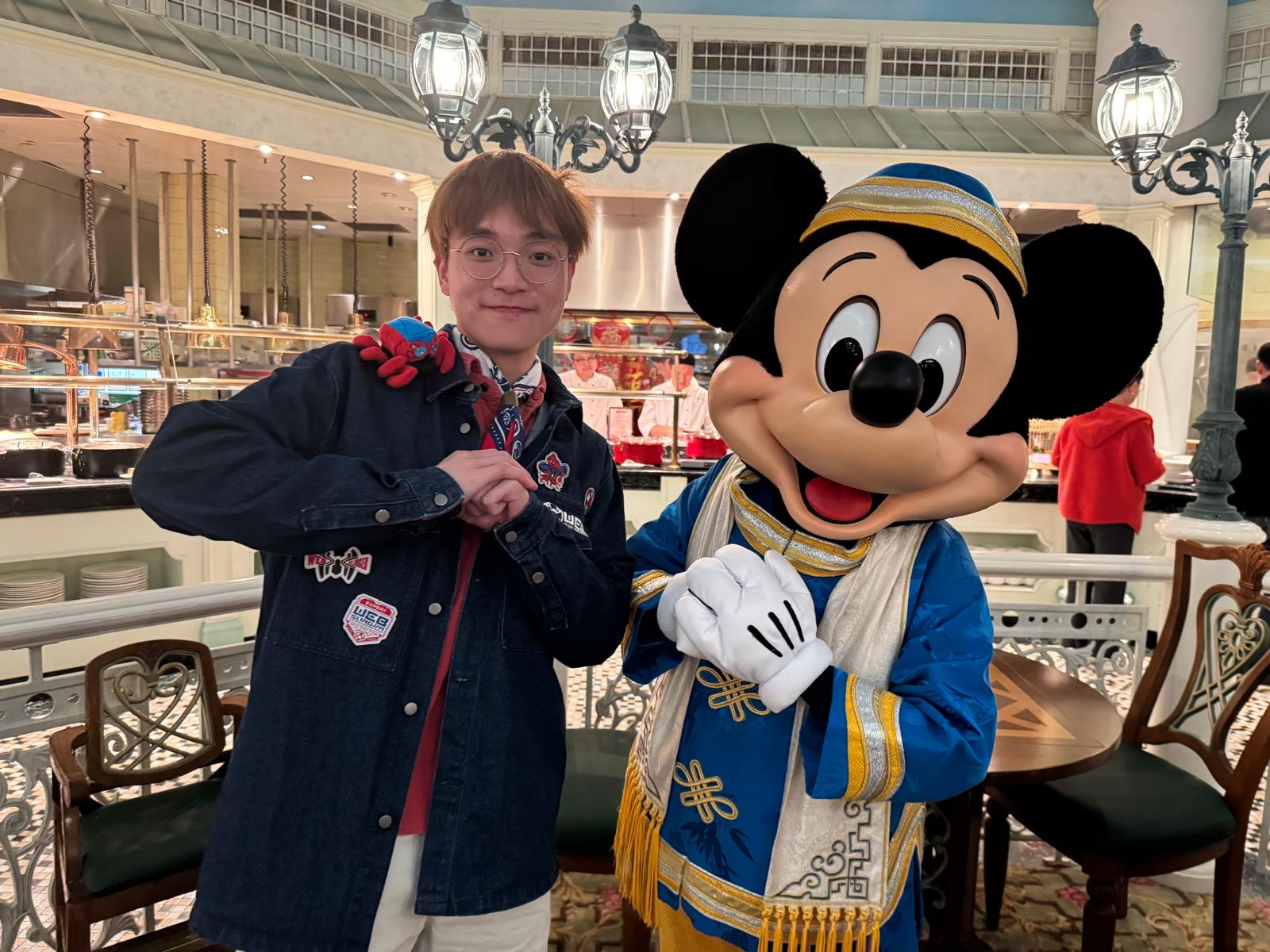 Boris posing with Mickey Mouse at Hong Kong Disneyland.