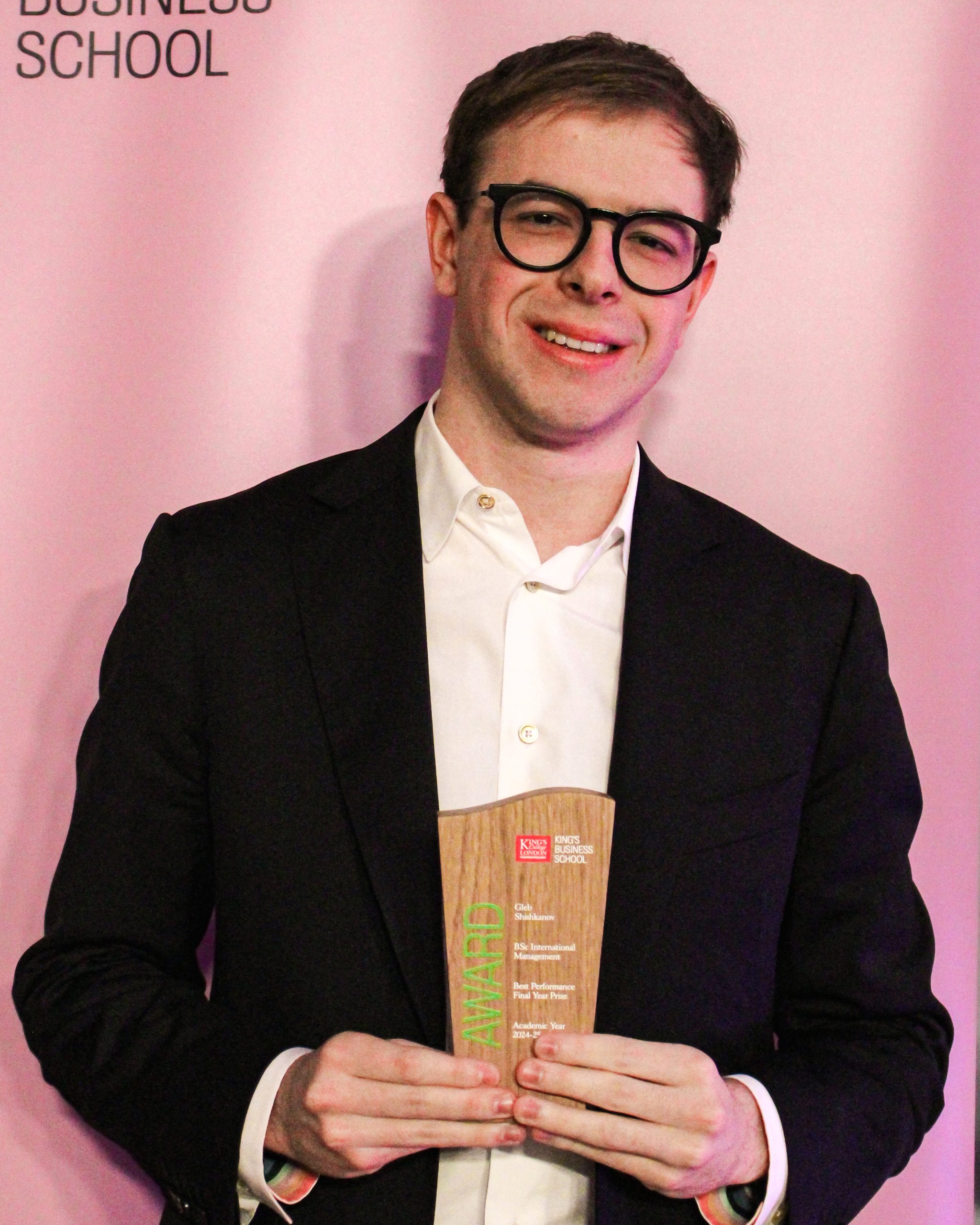 Disney team member holding a professional award, representing career progression and international opportunities after completing a Disney internship.