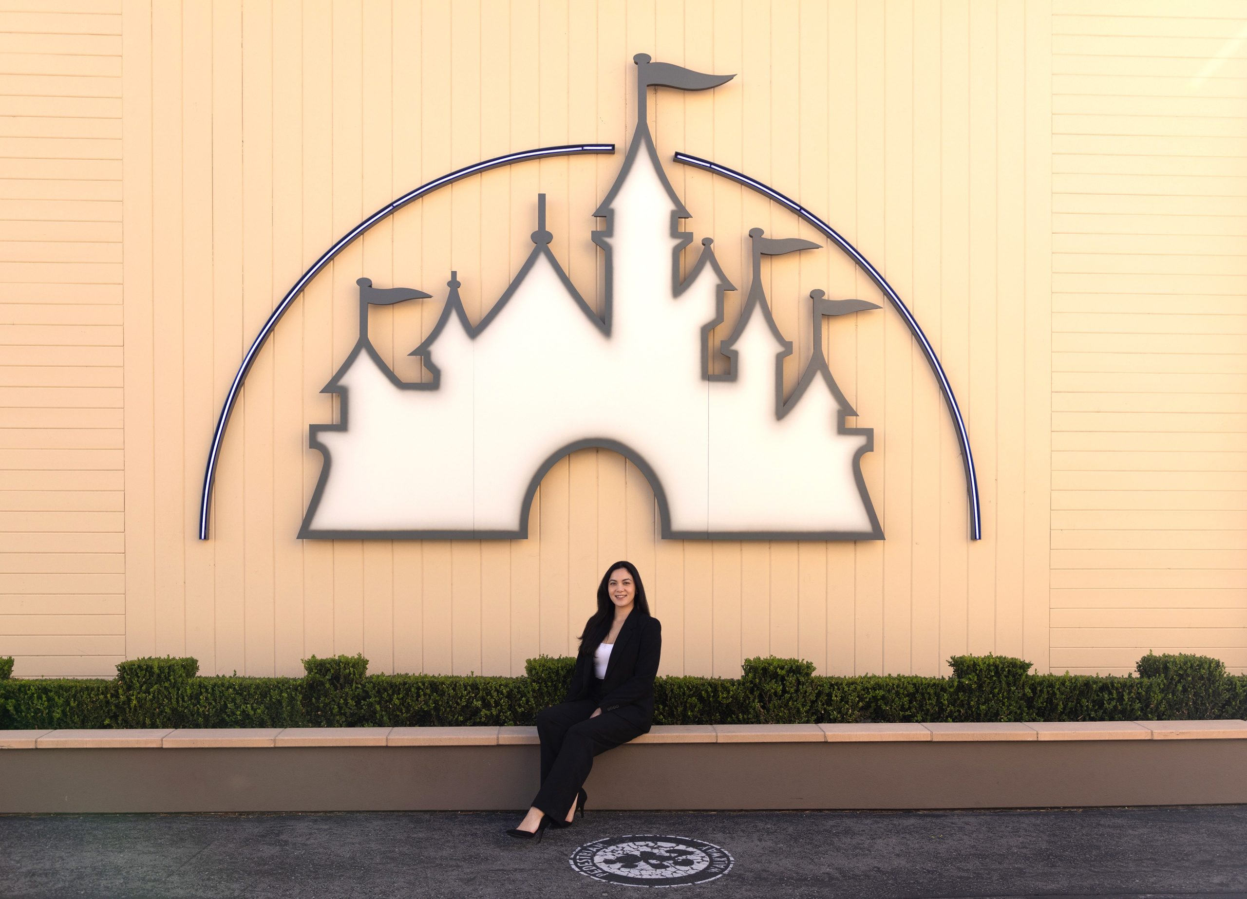 Carissa sitting in front of castle logo in Burbank.