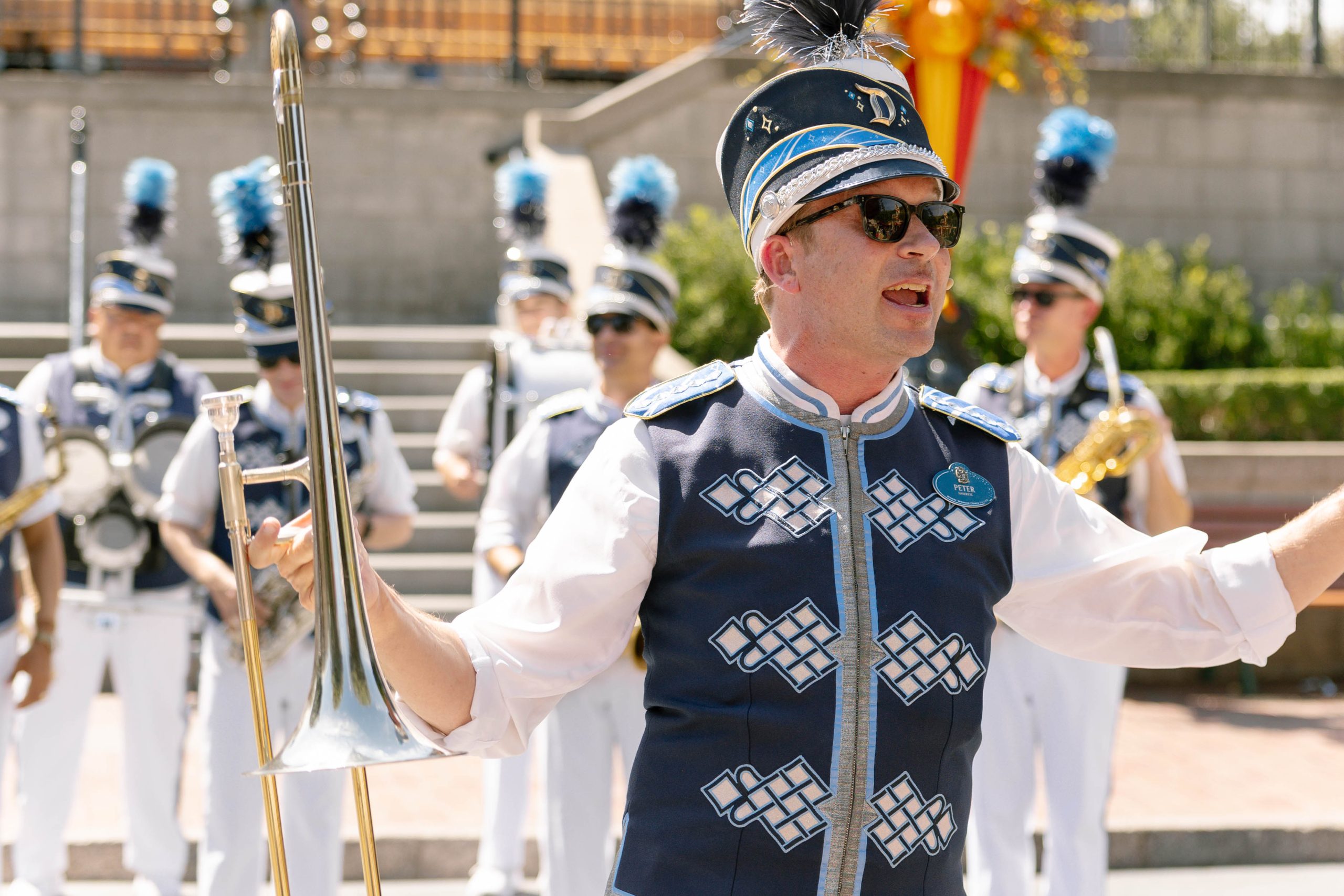 Photo of Disneyland band member in front of the band, speaking to the audience