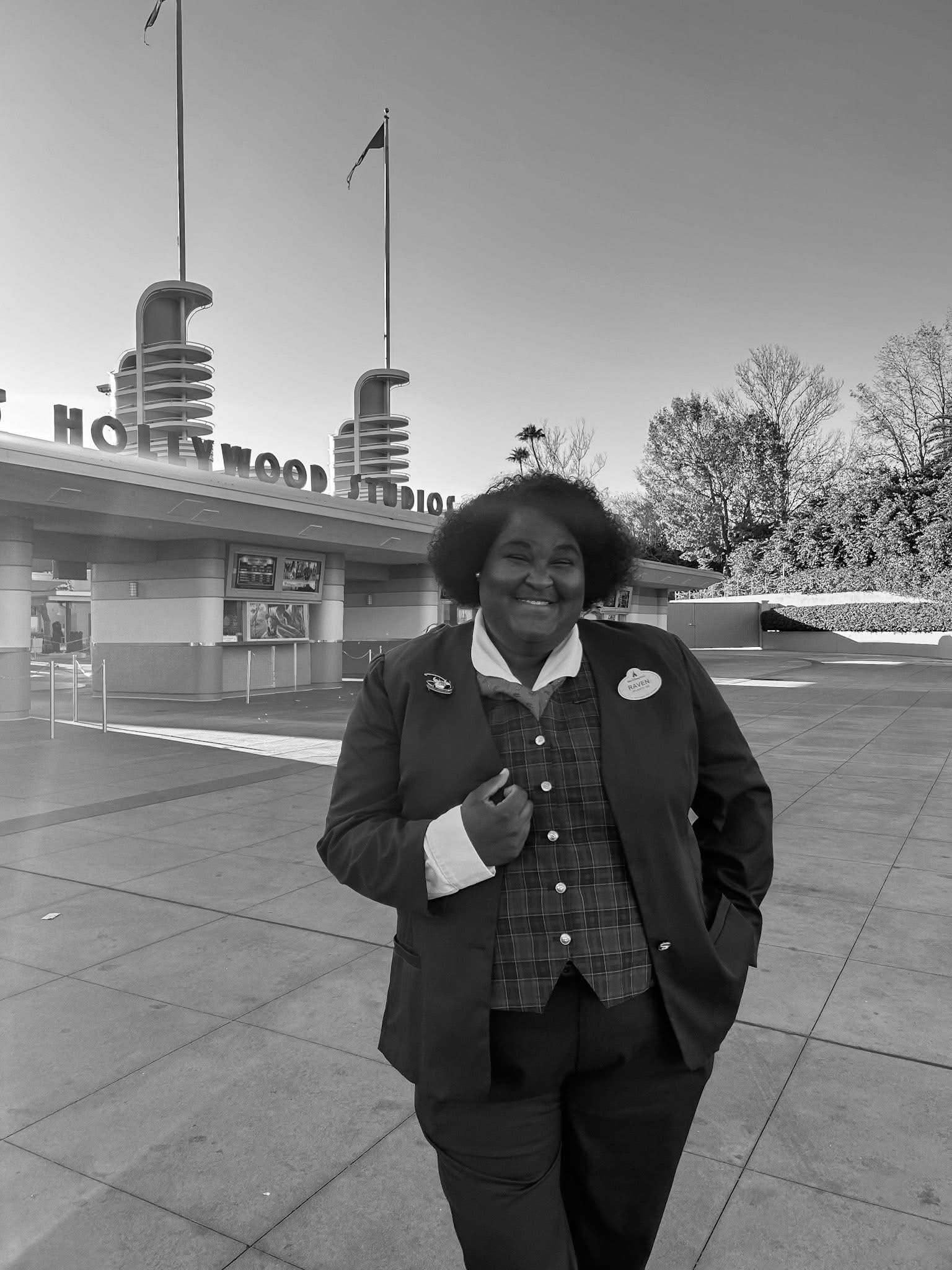 Guest Relations cast member smiling outside in front of Disney's Hollywood Studios.