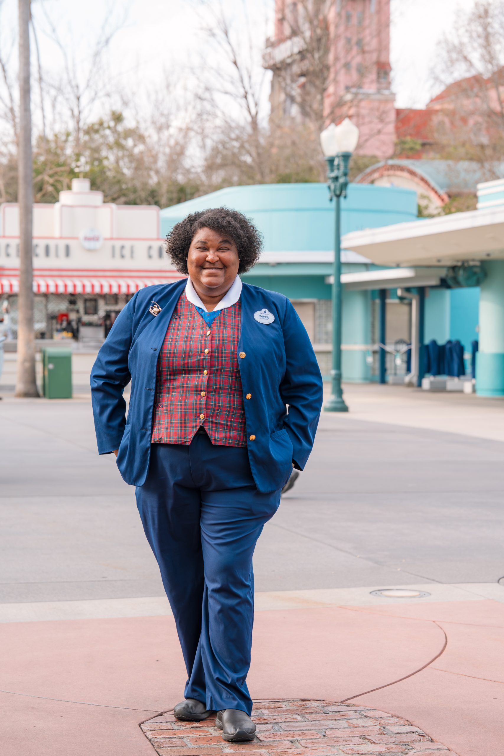 Guest Relations cast member smiling outside in front of Disney's Hollywood Studios.