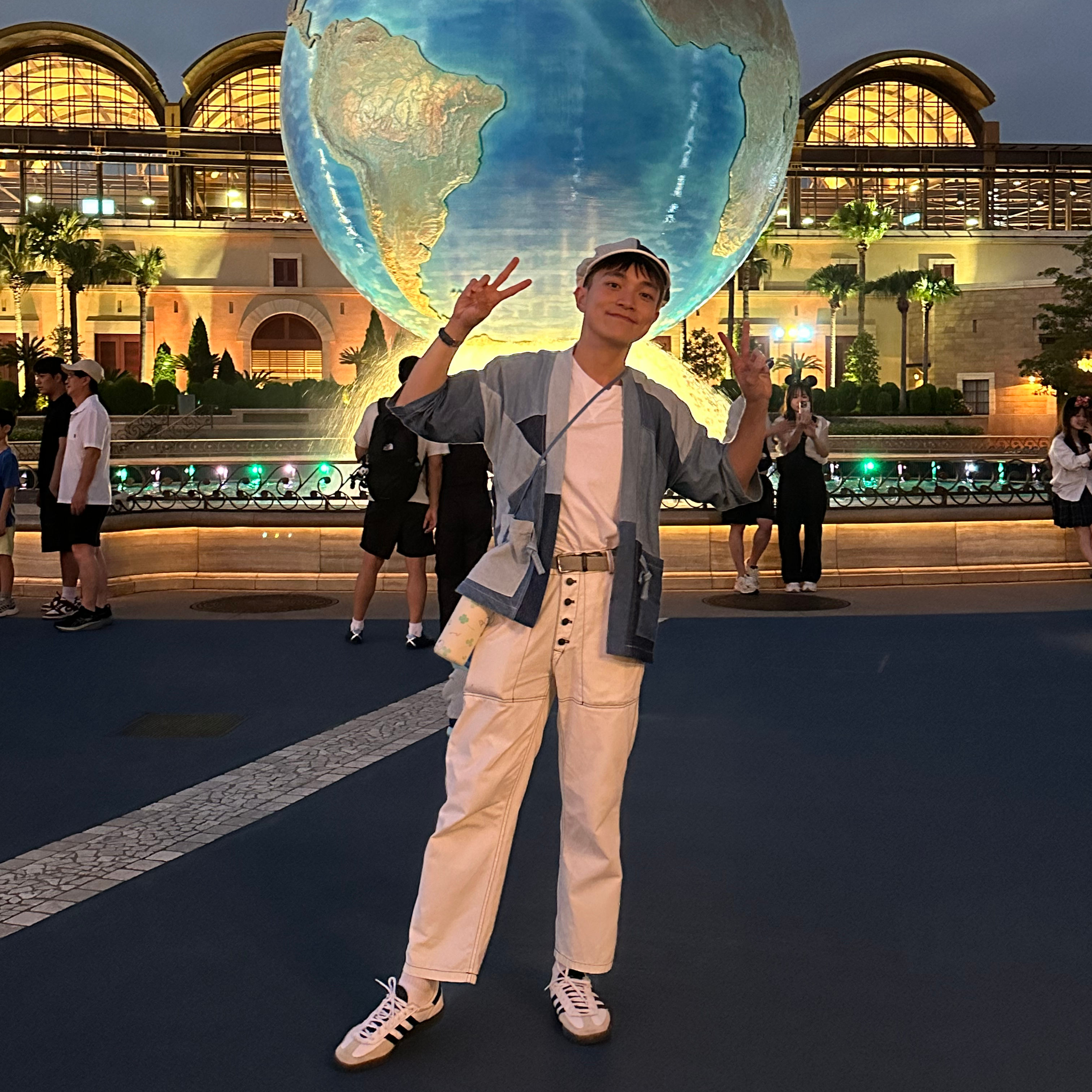 Boris posing in front of globe at Hong Kong Disneyland