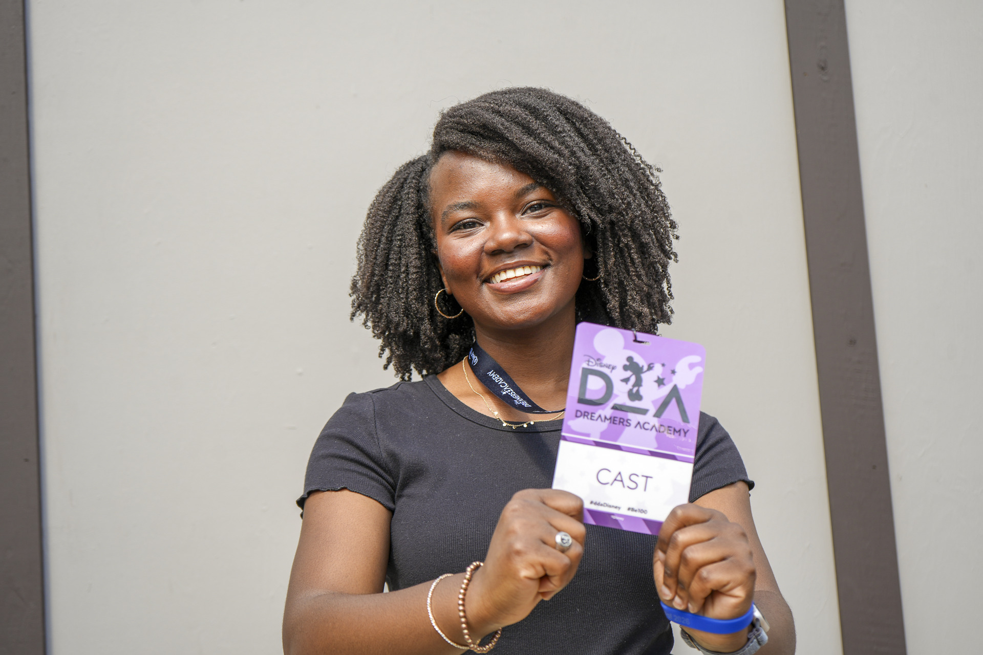 April holds up her Cast Member badge at DDA.