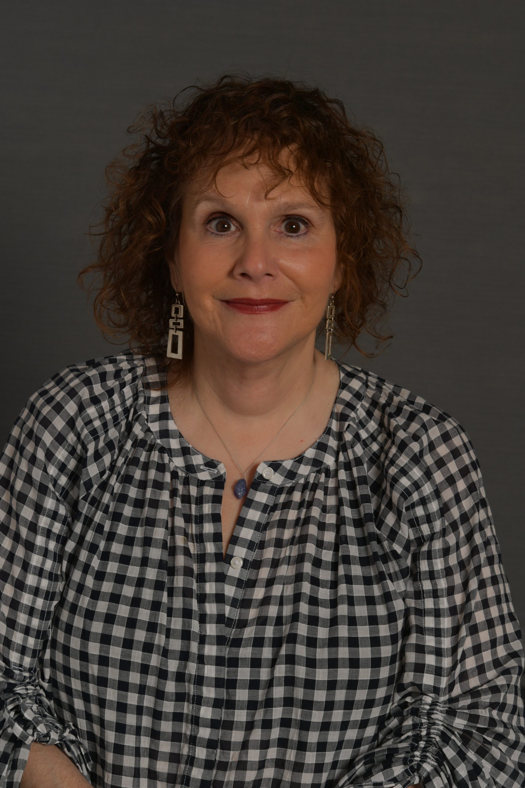 Studio headshot of Dani, Director of Artists & Repertoire at Disney Music Group, who shares insights on reimagining iconic Disney songs for new audiences on the Life at Disney podcast.