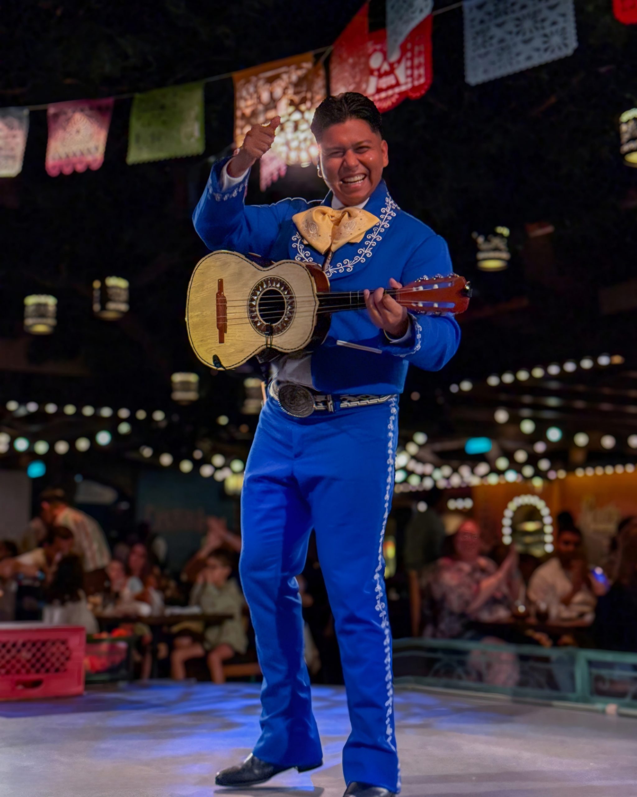 Performer playing the vihuela in the blue suit on Disney Cruise Line