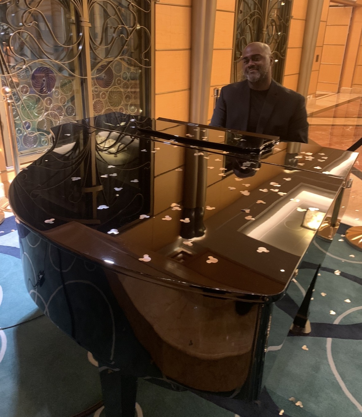 Pianist playing a grand piano on Disney Cruise Line