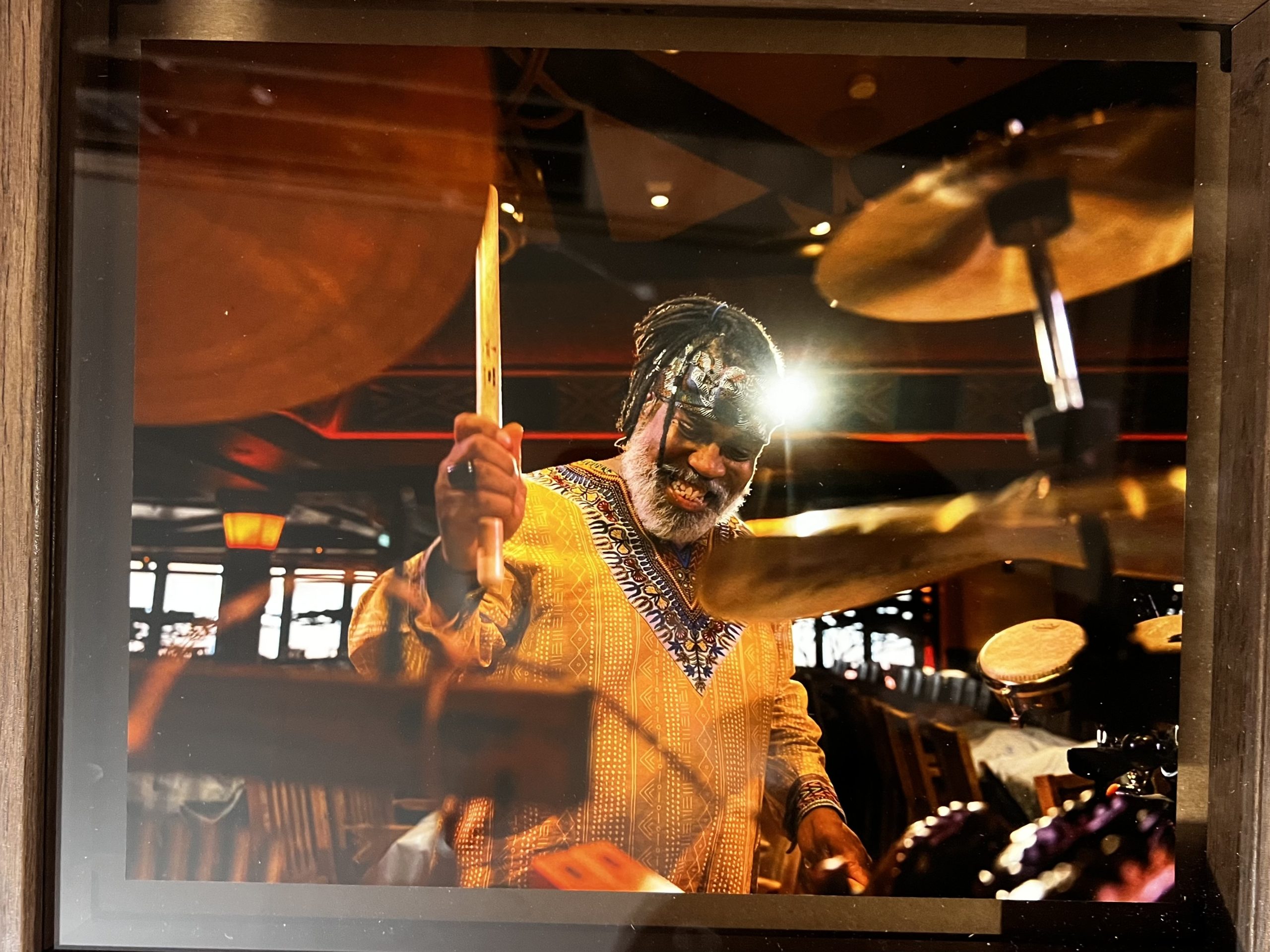 Photo of percussionist in a yellow shirt playing the drums on Disney Cruise Line