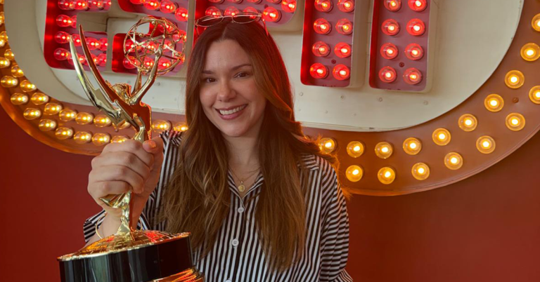 ESPN Associate Producer Mireya poses with an Emmy Award in front of an ESPN sign, highlighting career growth and achievement in sports broadcasting and live television production.