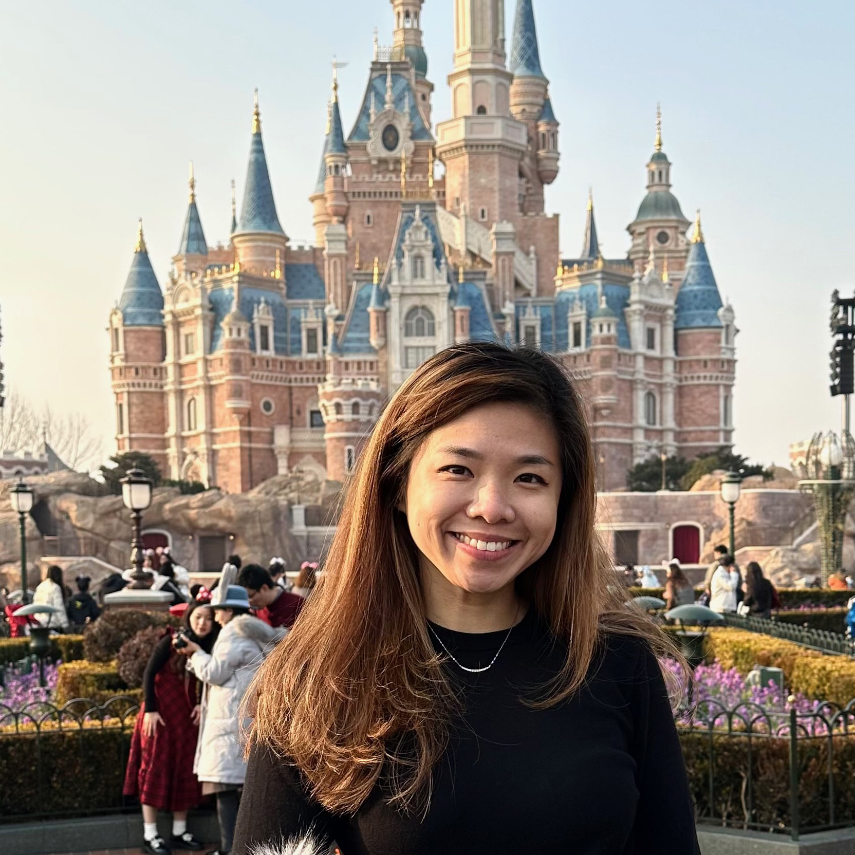 Smiling professional recruiter in front of the castle at Shanghai Disney Resort