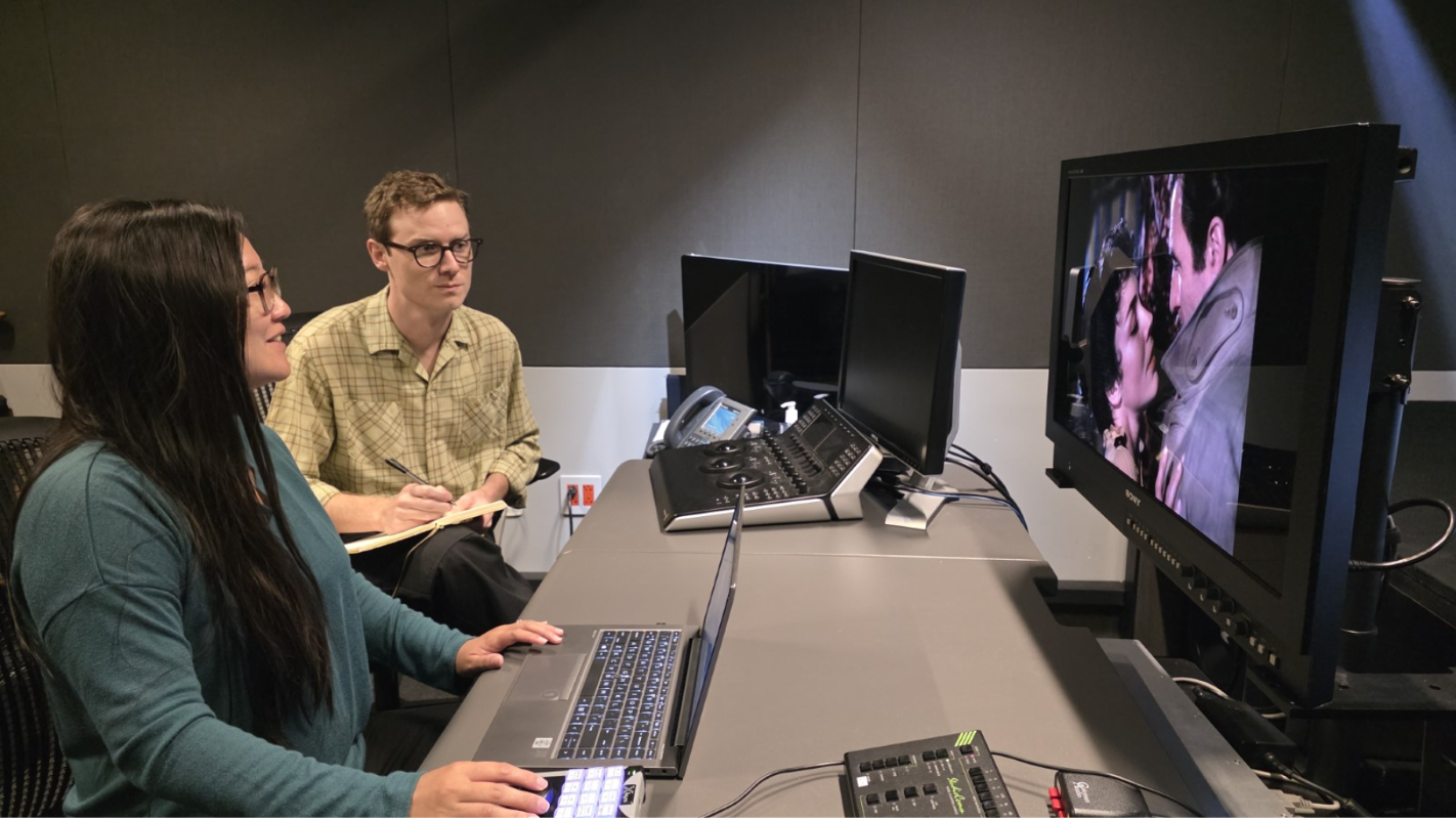 Nikki, manager of Restoration and Preservation, and Kellen review Disney footage at a film restoration workstation.