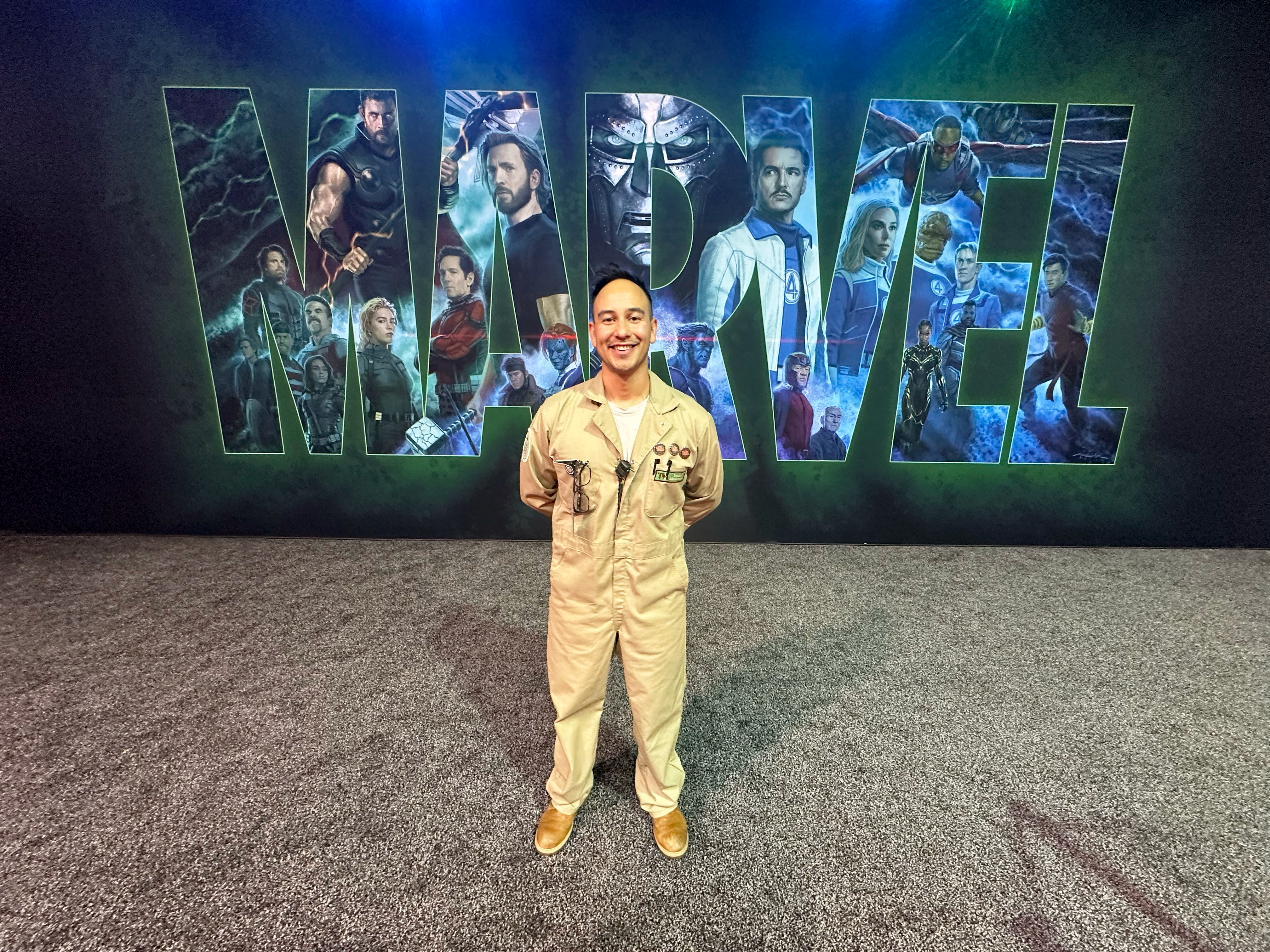 A Marvel Studios team member stands before a Marvel display at D23: The Ultimate Disney Fan Event, showcasing the creativity, storytelling, and entertainment careers behind iconic Marvel experiences and upcoming projects.