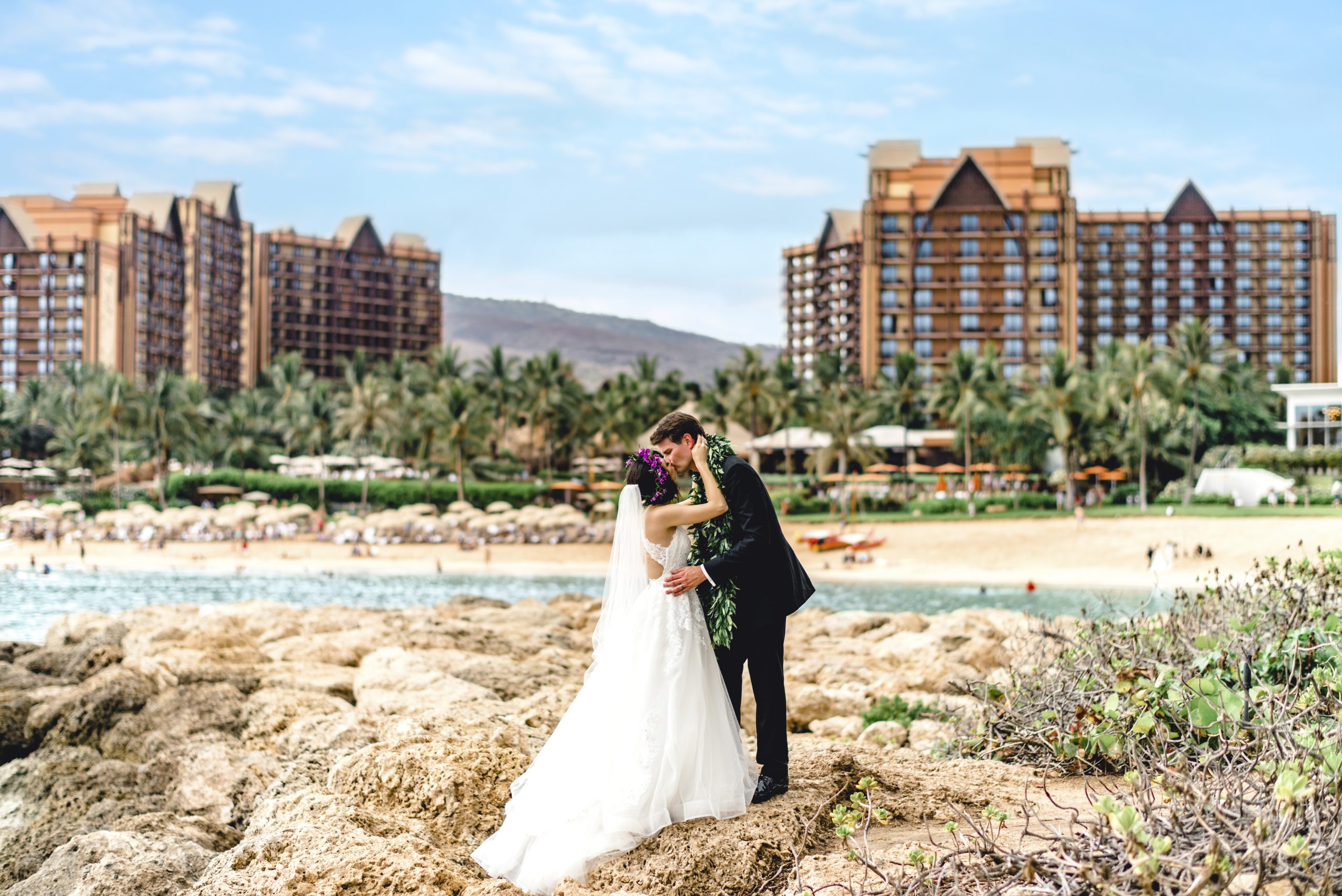 Wedding couple near the ocean at Aulani, a Disney Resort & Spa, a Disney&rsquo;s Fairy Tale Weddings destination.