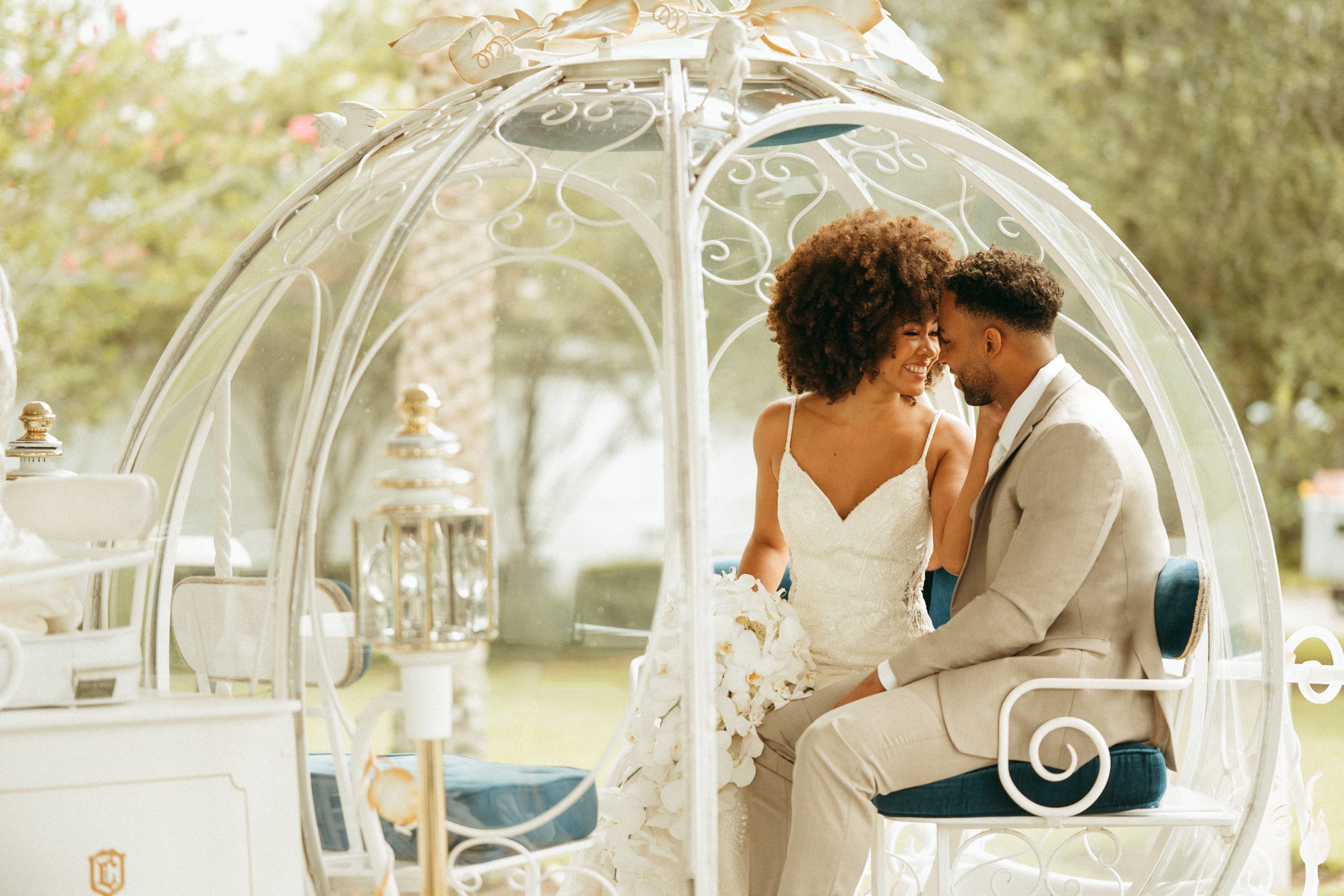 Couple seated together during an outdoor Disney wedding experience planned by the Disney&rsquo;s Fairy Tale Weddings team.