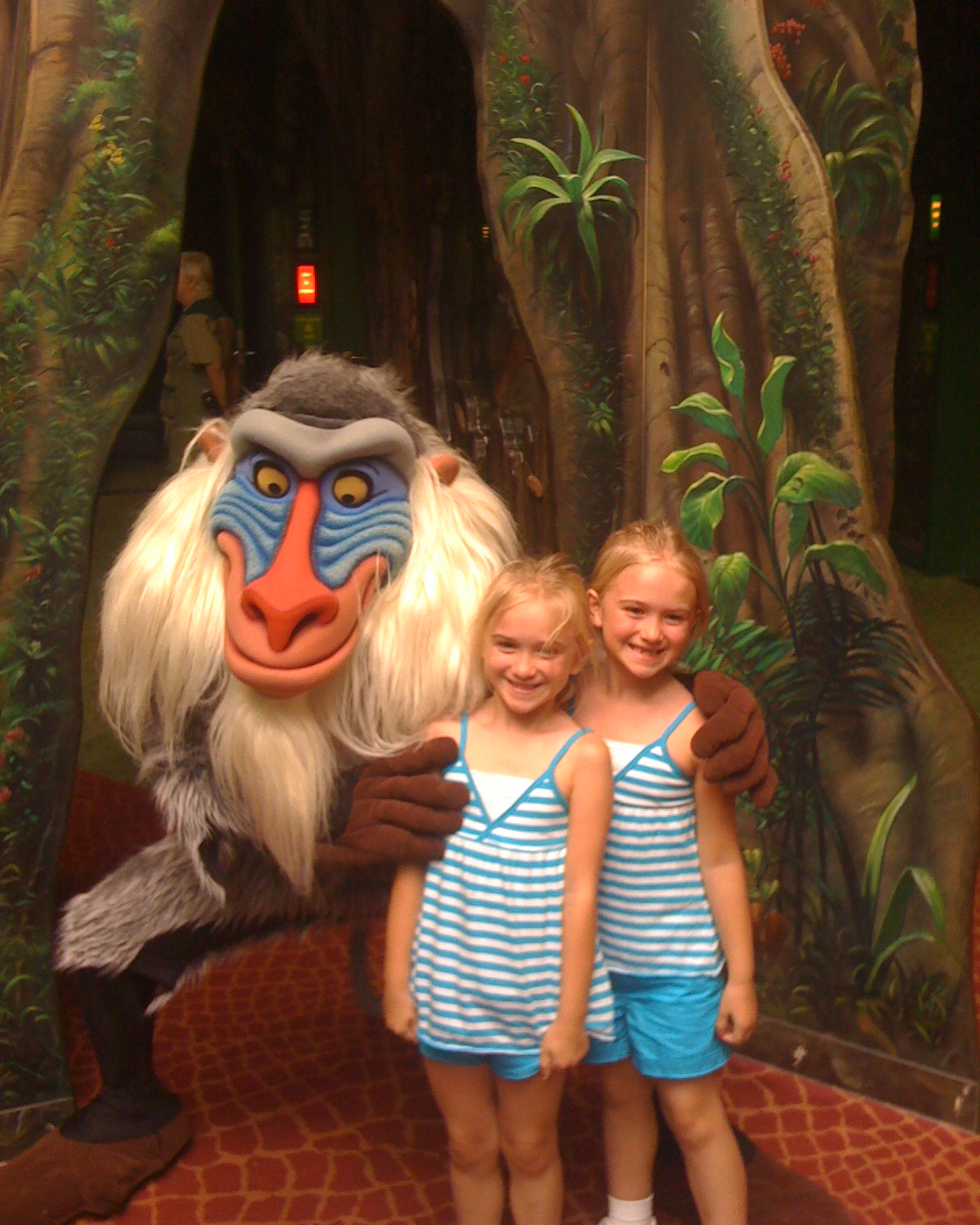 Two of the sisters posing with a Disney character during a childhood visit to Walt Disney World Resort.