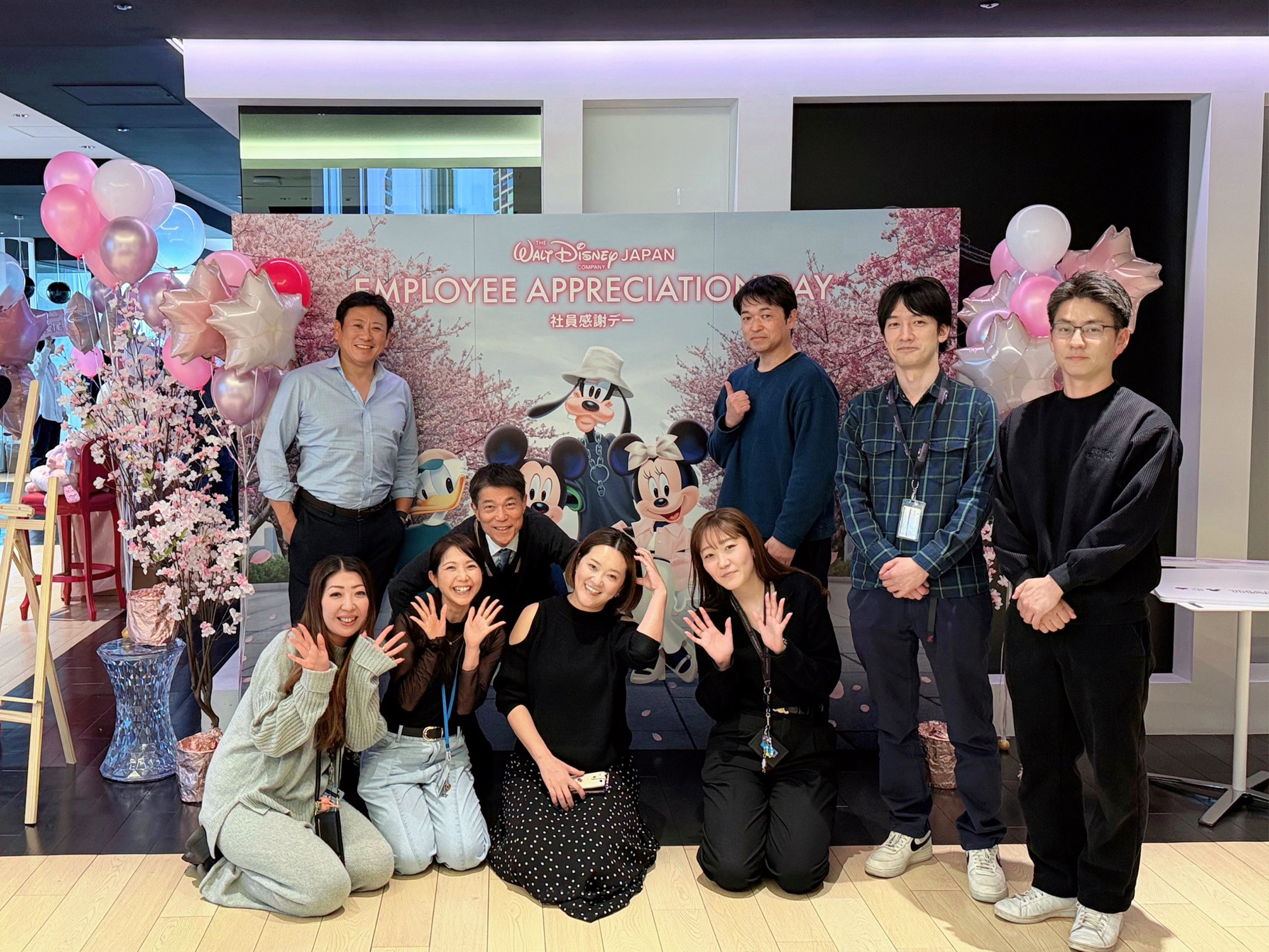 Disney Japan employees gather for an employee appreciation event with Disney-themed decorations.