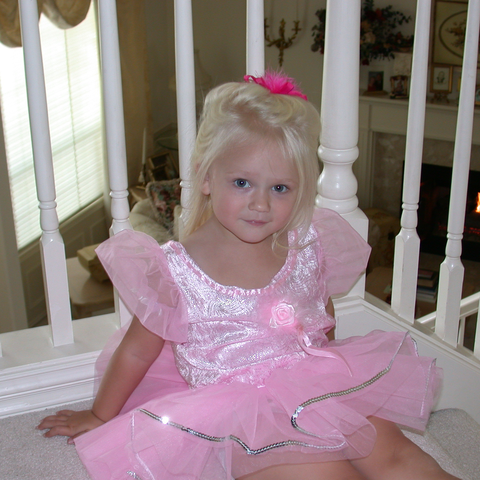 One of the sisters wearing a pink dance costume during her childhood years as a performer