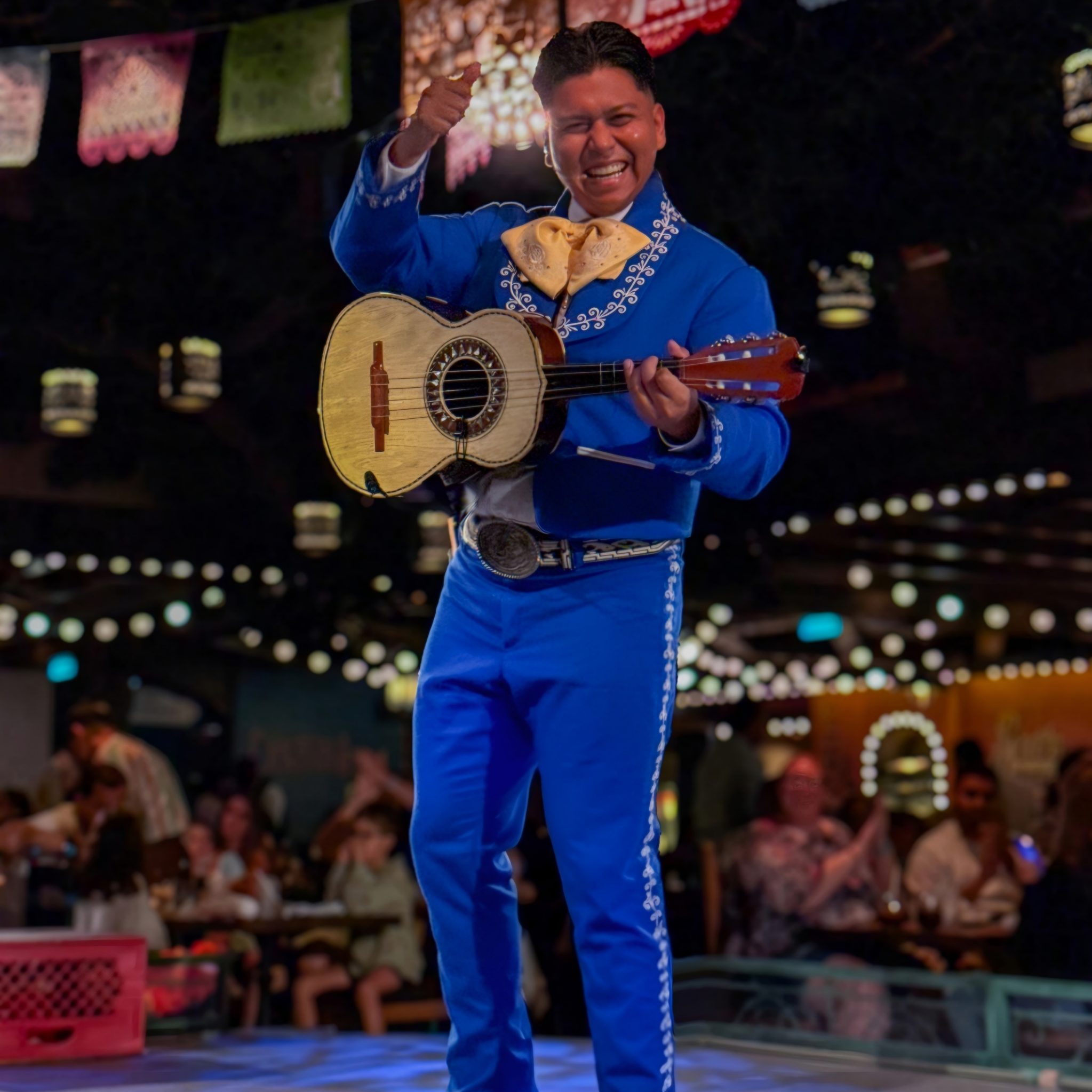 Performer playing the vihuela in the blue suit on Disney Cruise Line