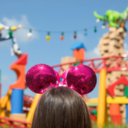 woman in pink Minnie Mouse ears in Toy Story Land at Disney's Hollywood Studios