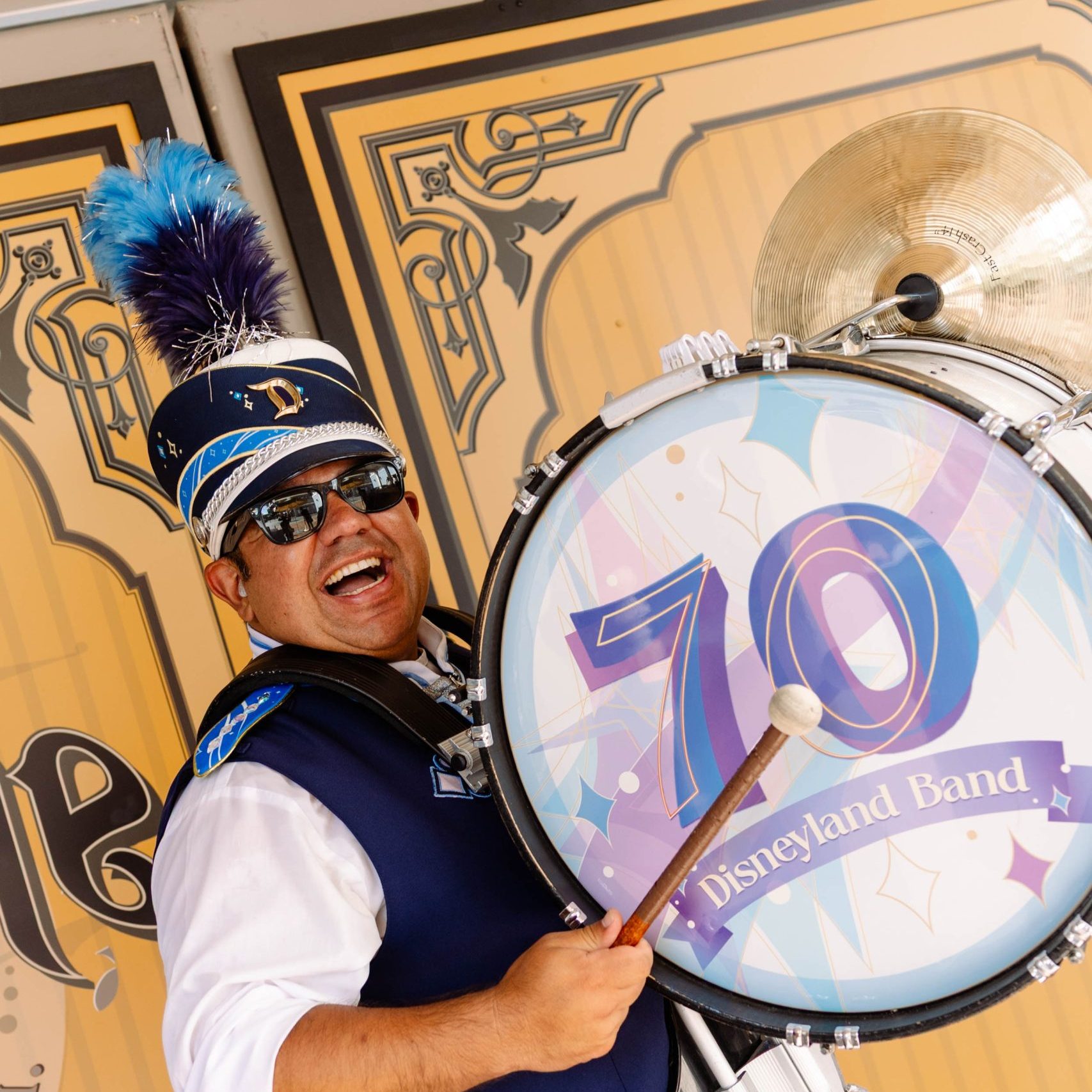 Headshot of bass drum player in front of brown wall
