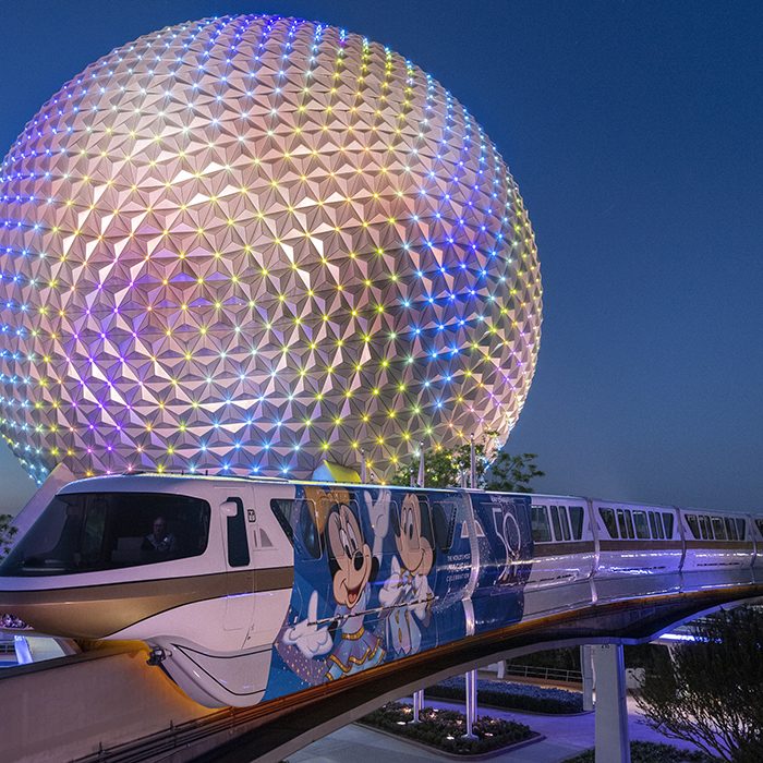 The monorail at dusk in front of the Spaceship Earth attraction at Epcot at the Walt Disney World Resort