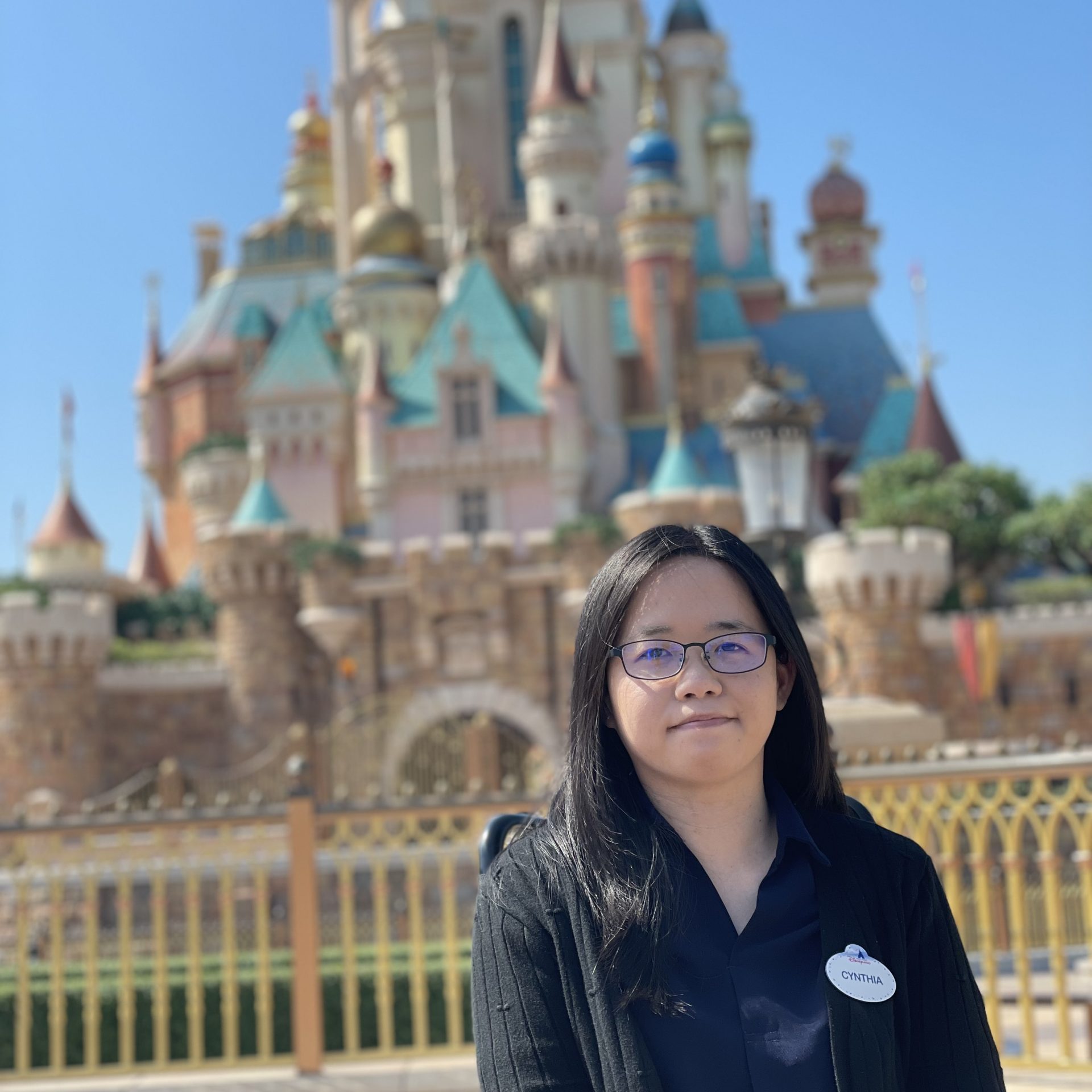 Image of employee in front of castle at Hong Kong Disneyland Resort