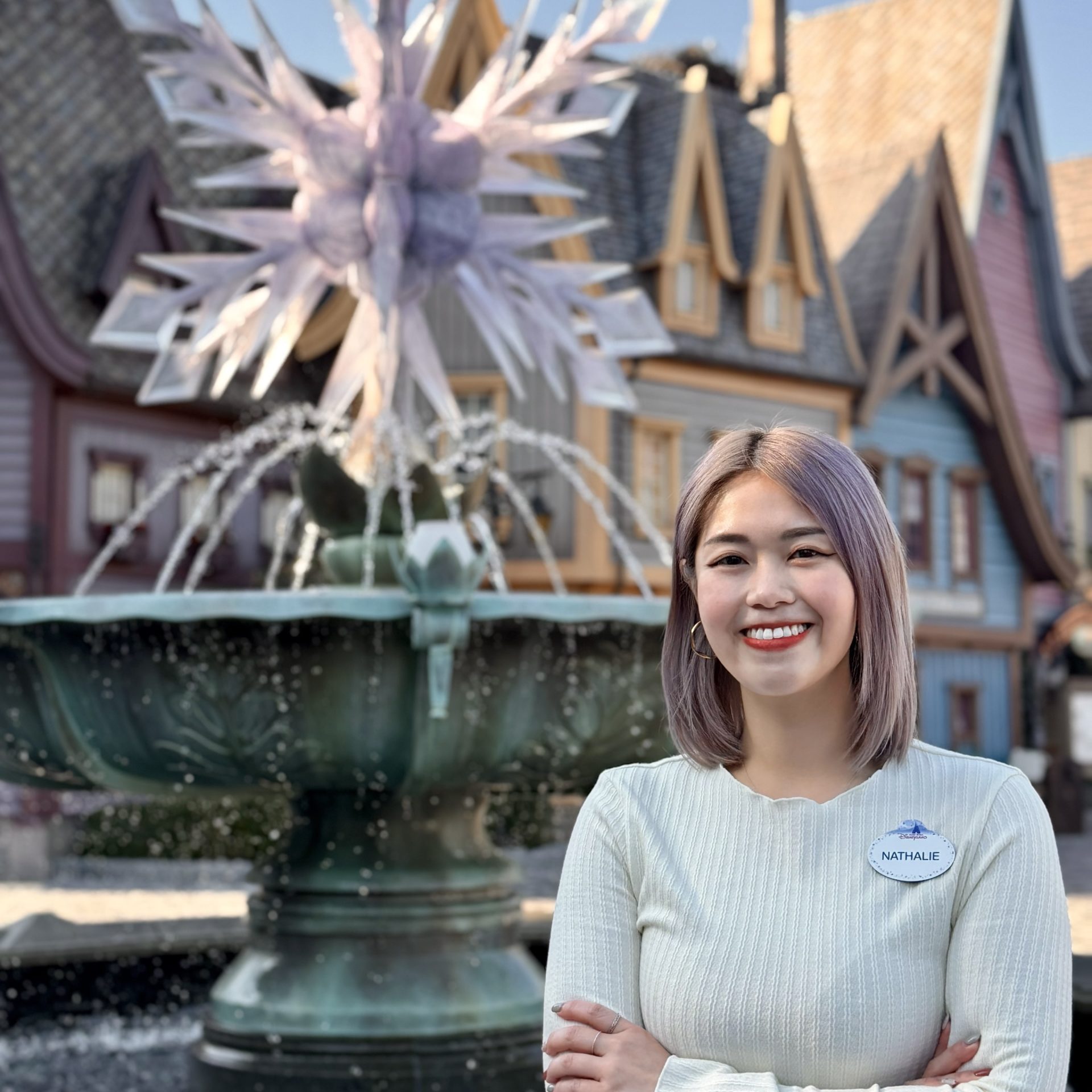 Image of employee in front of fountain at Hong Kong Disneyland