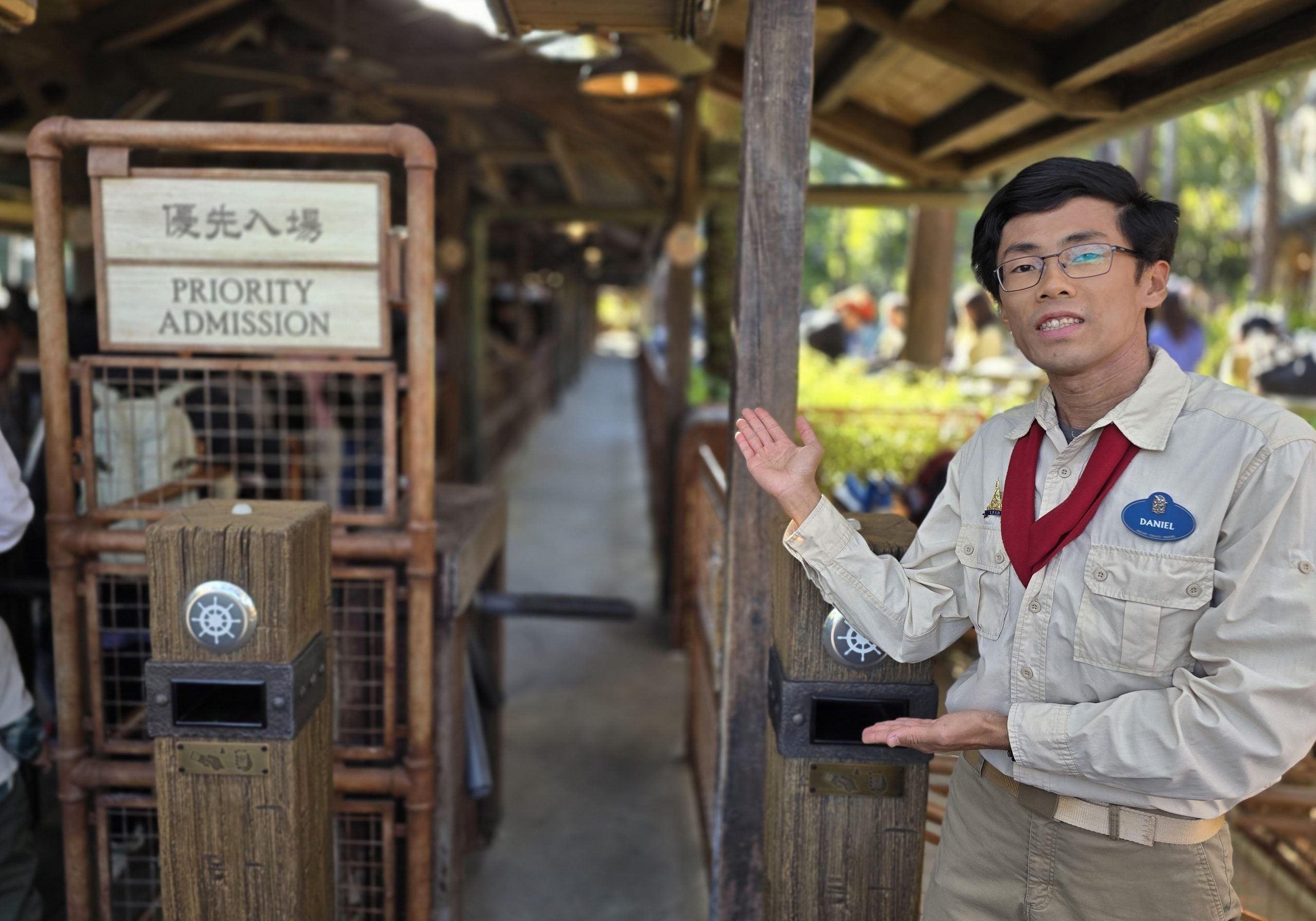 Image of employee in front of attraction entrance.