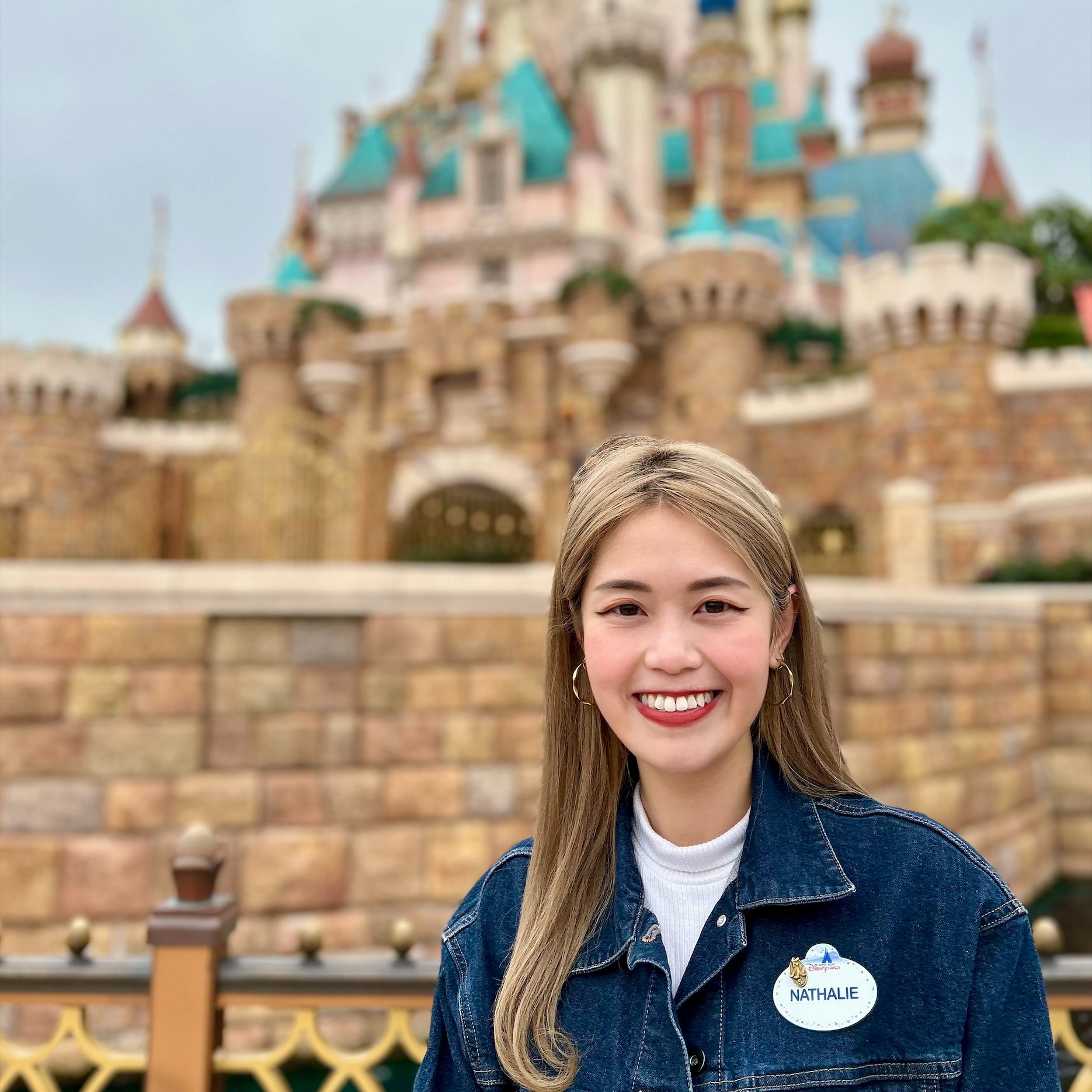 Image of employee in front of castle at Hong Kong Disneyland
