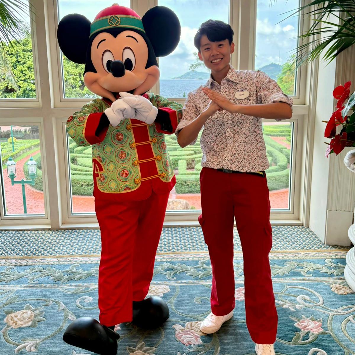 Image of employee posing with Mickey Mouse