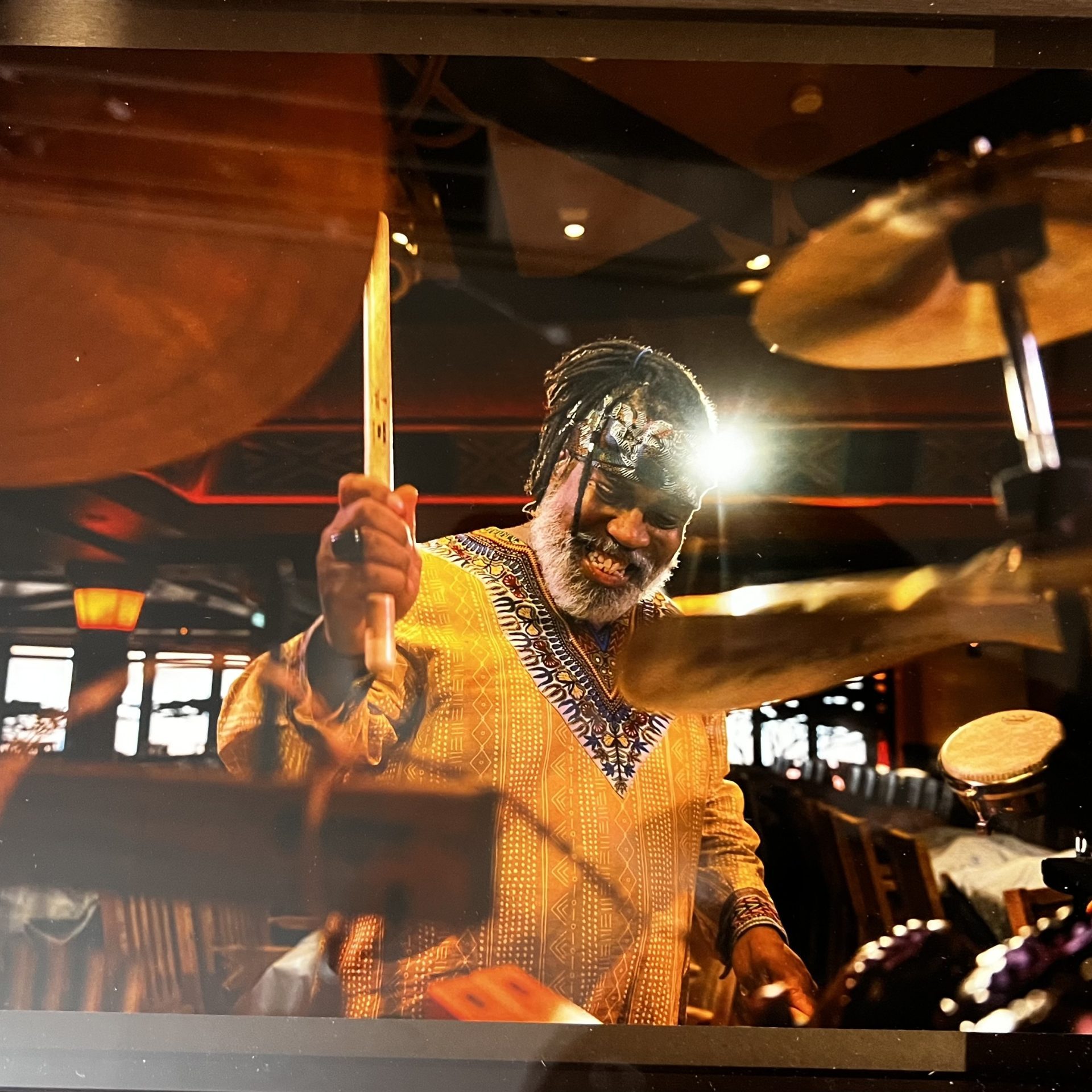 Photo of percussionist in a yellow shirt playing the drums on Disney Cruise Line