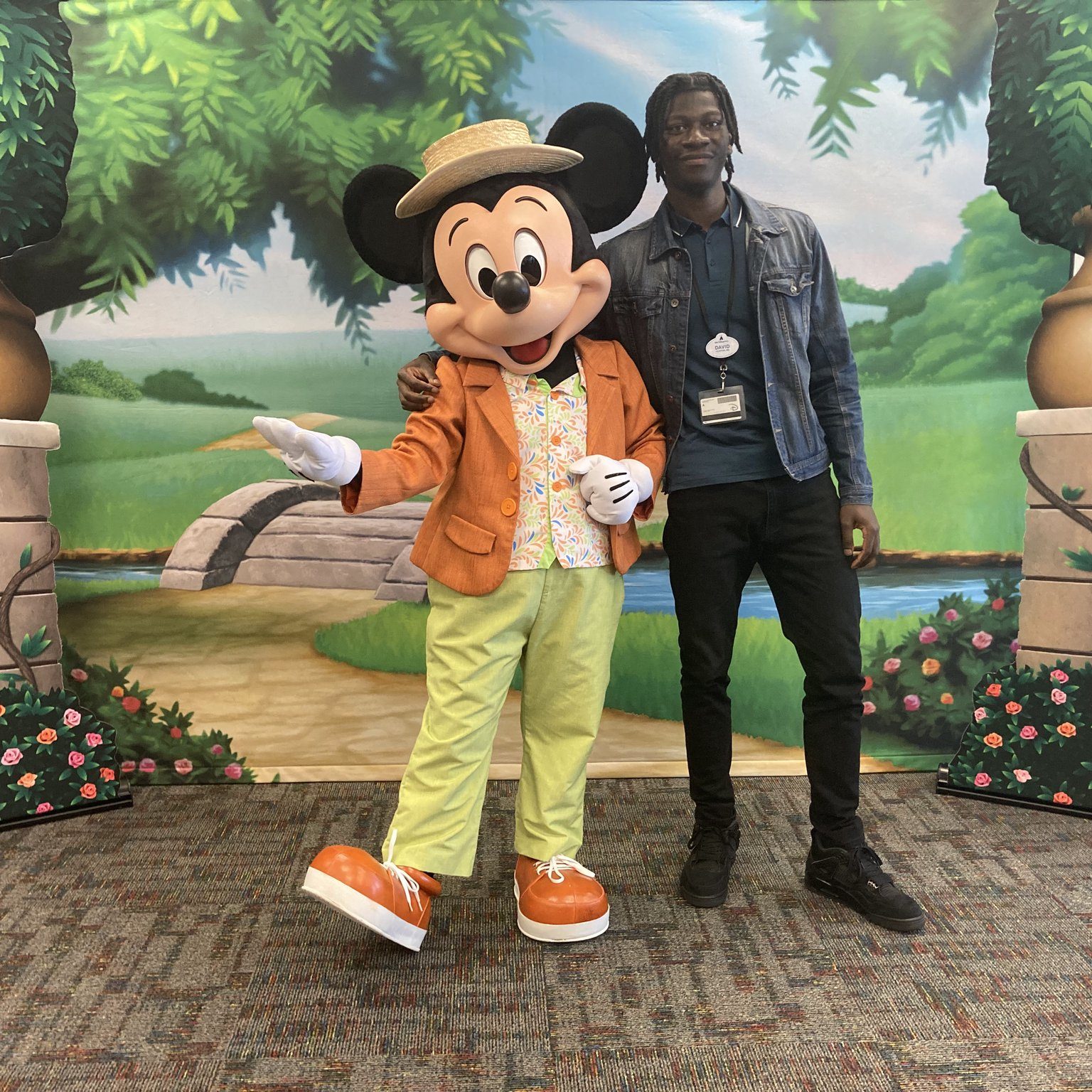 Intern posing with Mickey Mouse