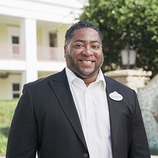Headshot of a black man in a business suite