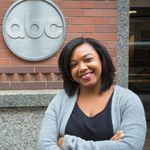 Black female standing in front of the ABC building