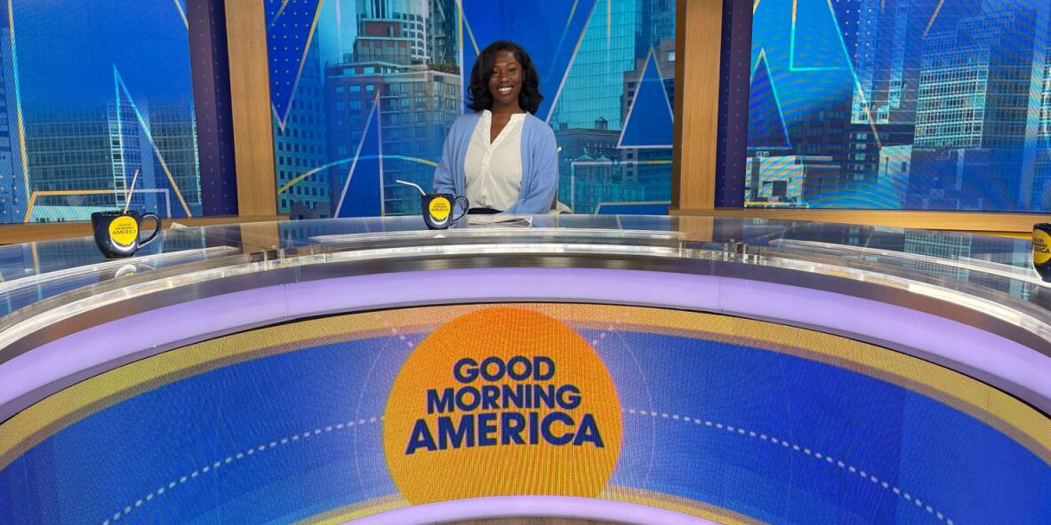 Female Disney future storytellers participant smiling while sitting at the Good Morning America broadcast set. She is wearing a collared white shirt and a light blue cardigan.