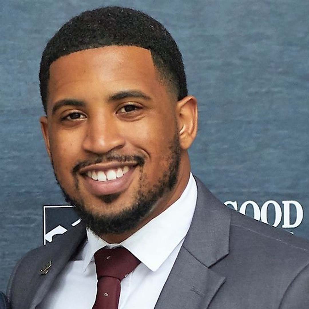 Florida A&M Alumnus and Disney Experiences employee, Jonathan. He is smiling while wearing a grey suit with a white shirt and burgundy tie.